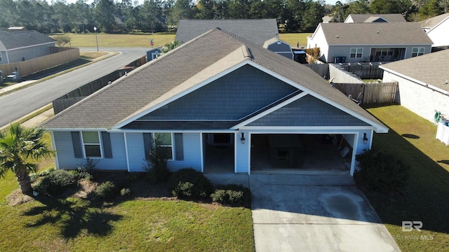 view of front of property with a garage and a front lawn