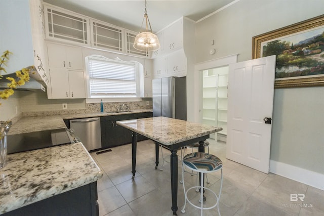 1206 Palmetto St, Mobile, AL 36604 - kitchen featuring stainless steel appliances, white cabinetry, light tile patterned flooring, and ornamental molding