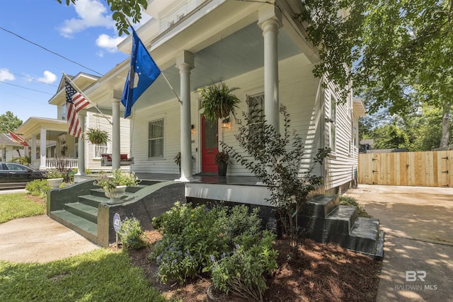 1206 Palmetto St, Mobile, AL 36604 - view of home's exterior featuring covered porch and a gate