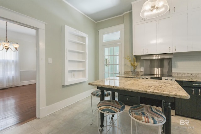 1206 Palmetto St, Mobile, AL 36604 - kitchen with a chandelier, white cabinetry, ornamental molding, tasteful backsplash, and pendant lighting