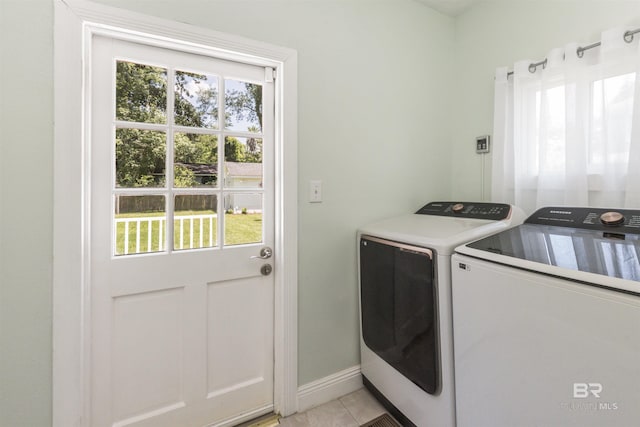 1206 Palmetto St, Mobile, AL 36604 - laundry area with washer and clothes dryer, baseboards, and light tile patterned flooring