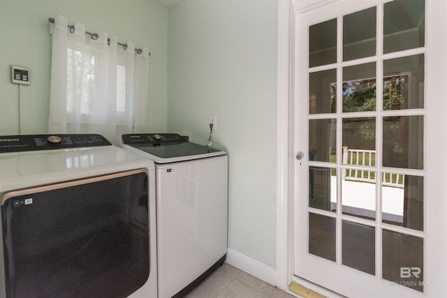 1206 Palmetto St, Mobile, AL 36604 - laundry room featuring washing machine and clothes dryer, light tile patterned floors, and plenty of natural light