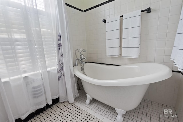 1206 Palmetto St, Mobile, AL 36604 - full bathroom featuring a freestanding bath, tile walls, and tile patterned floors