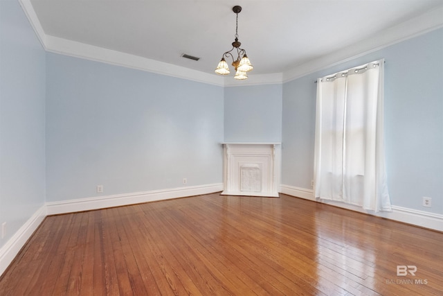 1206 Palmetto St, Mobile, AL 36604 - spare room with a chandelier, hardwood / wood-style floors, ornamental molding, baseboards, and a premium fireplace
