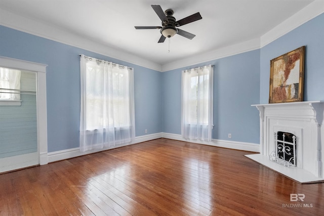 1206 Palmetto St, Mobile, AL 36604 - unfurnished living room featuring ceiling fan, wood-type flooring, a fireplace, and baseboards