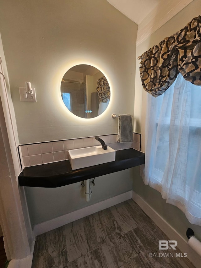 1206 Palmetto St, Mobile, AL 36604 - bathroom featuring a sink, baseboards, and decorative backsplash
