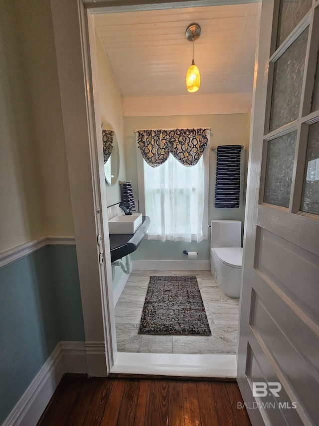 1206 Palmetto St, Mobile, AL 36604 - bathroom with baseboards, toilet, and wood finished floors