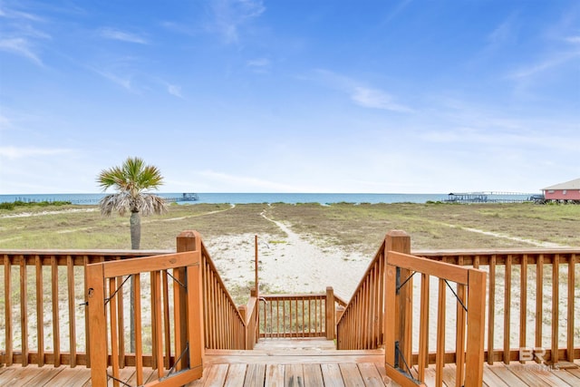 wooden terrace with a water view and a beach view