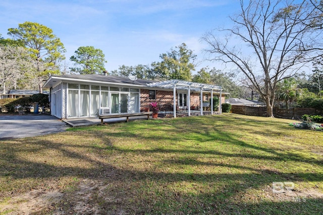 back of house with a yard and a pergola