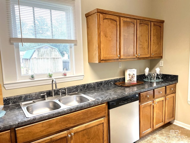 kitchen featuring dishwasher, light tile patterned flooring, a wealth of natural light, and sink