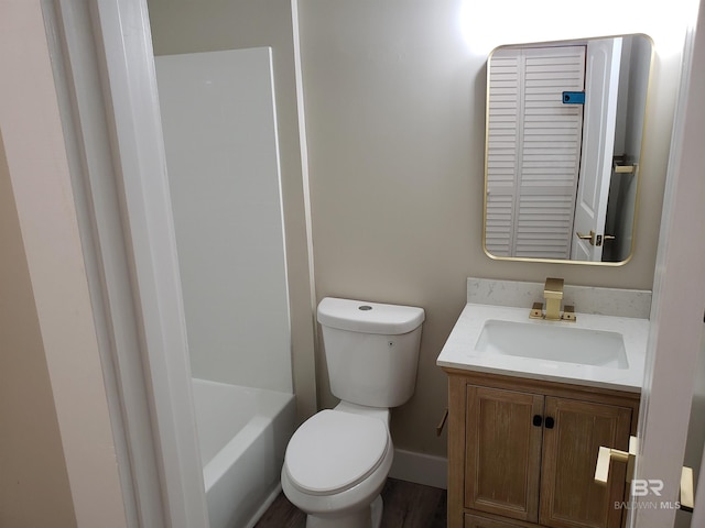 bathroom featuring vanity, toilet, and hardwood / wood-style floors