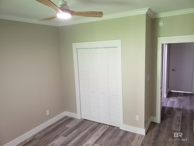 unfurnished bedroom featuring ceiling fan, ornamental molding, and dark hardwood / wood-style floors