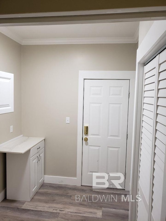 interior space with ornamental molding and dark hardwood / wood-style flooring