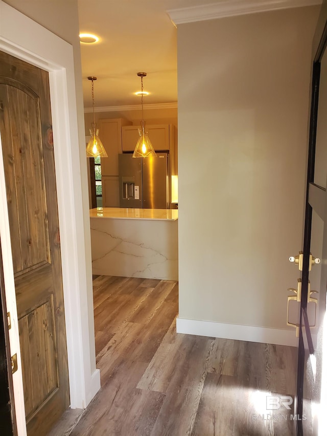 interior space featuring crown molding and wood-type flooring