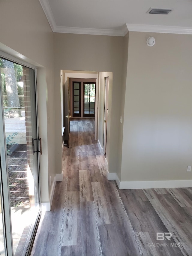 hall featuring a wealth of natural light, crown molding, hardwood / wood-style flooring, and french doors