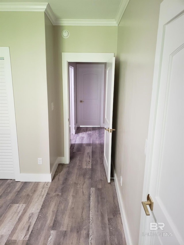 hallway with ornamental molding and dark hardwood / wood-style floors