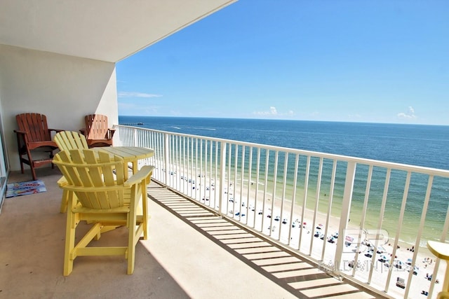 balcony with a water view and a beach view