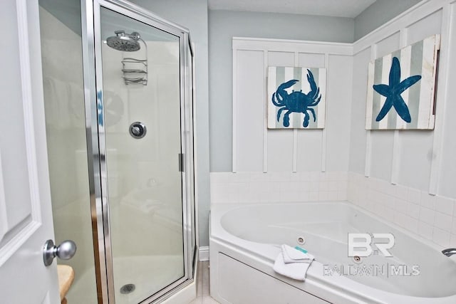 bathroom featuring a stall shower and a garden tub