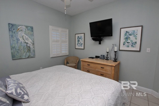 bedroom with baseboards, ceiling fan, and tile patterned floors