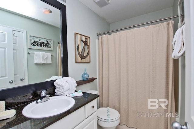 bathroom with toilet, curtained shower, vanity, and visible vents