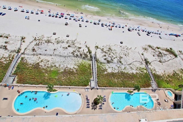 birds eye view of property featuring a water view and a view of the beach