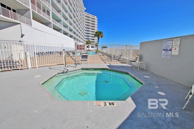 view of pool with a patio and fence