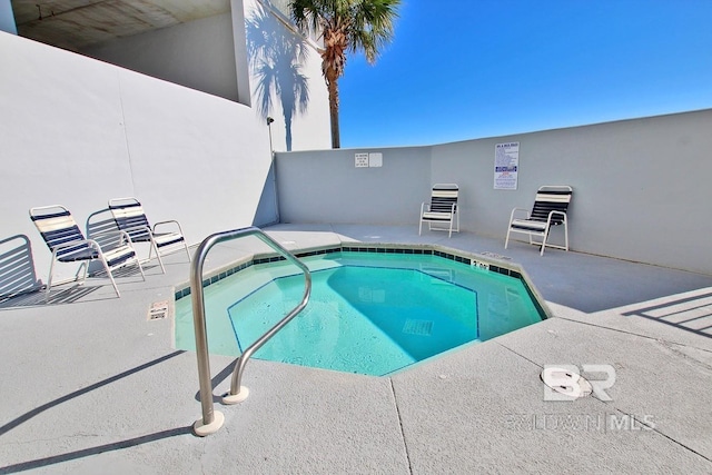 view of swimming pool featuring a patio area