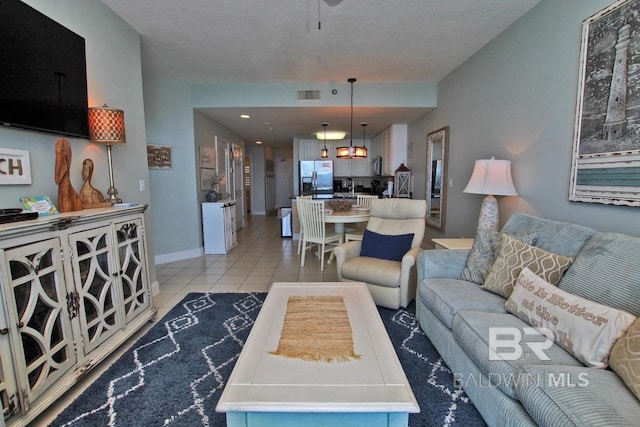 living area featuring visible vents, baseboards, and light tile patterned floors