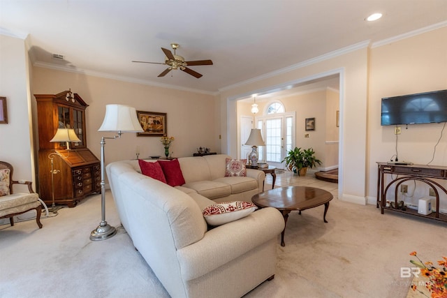 living room featuring light colored carpet, a ceiling fan, baseboards, and crown molding
