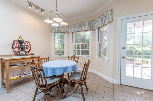dining space featuring light tile patterned floors, baseboards, and crown molding