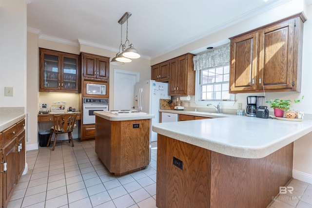kitchen with crown molding, light tile patterned flooring, white appliances, light countertops, and a peninsula
