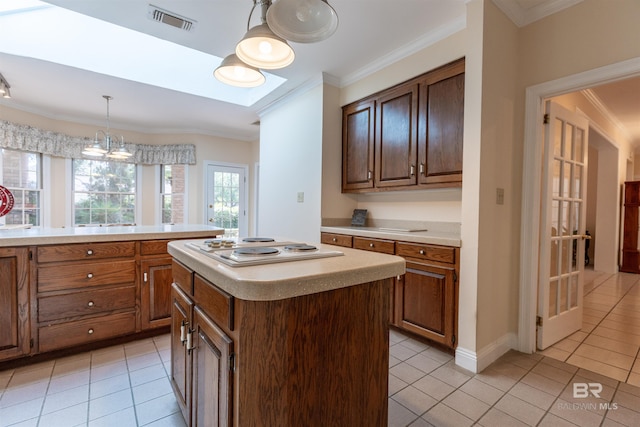 kitchen featuring crown molding, light tile patterned flooring, and visible vents
