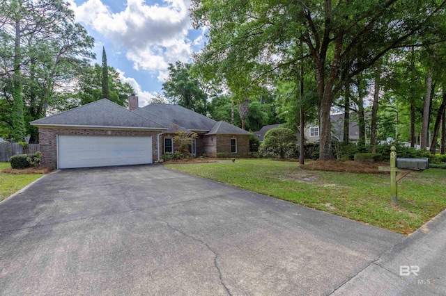 single story home with fence, a front lawn, aphalt driveway, a garage, and a chimney