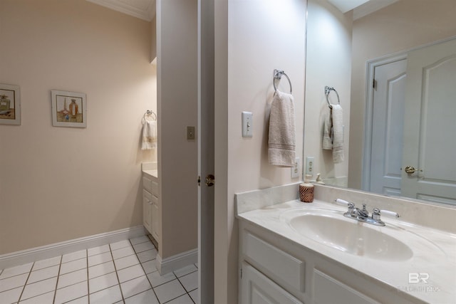 bathroom with baseboards, ornamental molding, tile patterned flooring, and vanity