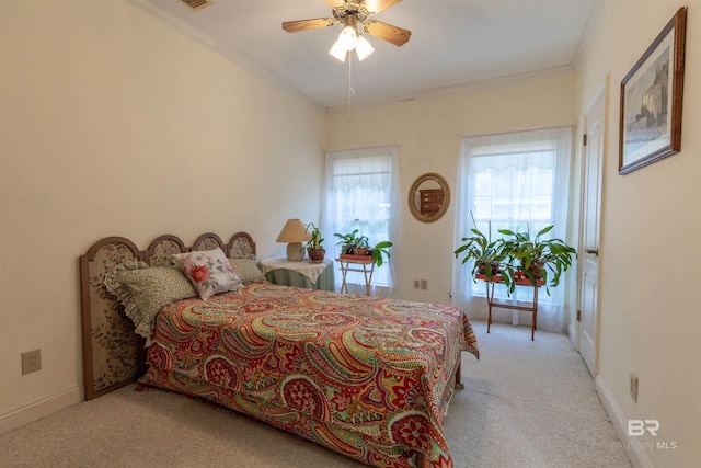 carpeted bedroom with ceiling fan, visible vents, ornamental molding, and baseboards