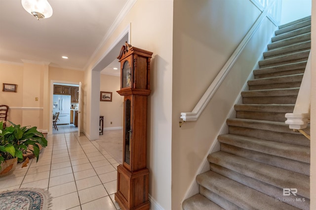 stairway featuring recessed lighting, baseboards, ornamental molding, and tile patterned flooring