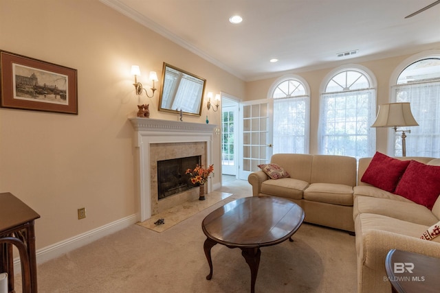 carpeted living room with visible vents, a fireplace, baseboards, ornamental molding, and recessed lighting