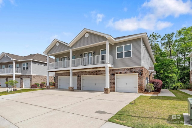 6877 Spaniel Dr Unit A, Spanish Fort, AL 36527 - view of front of home with an attached garage, brick siding, a front yard, and concrete driveway
