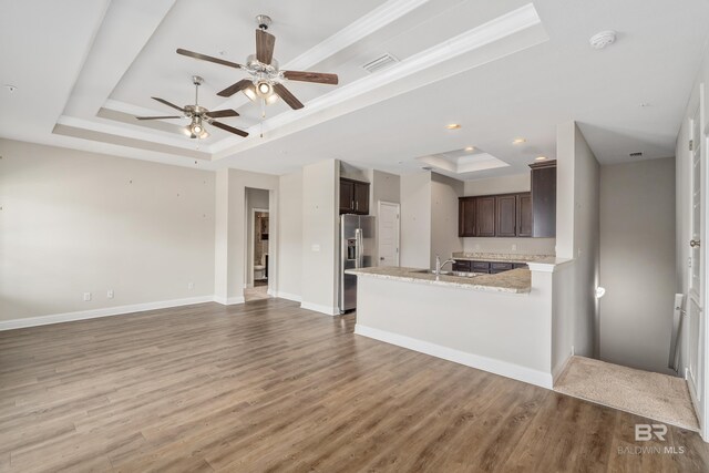 6877 Spaniel Dr Unit A, Spanish Fort, AL 36527 - unfurnished living room with a ceiling fan, visible vents, light wood finished floors, and a raised ceiling