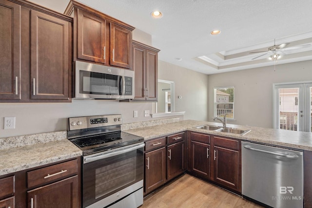 6877 Spaniel Dr Unit A, Spanish Fort, AL 36527 - kitchen with light wood finished floors, a sink, a peninsula, appliances with stainless steel finishes, and ceiling fan