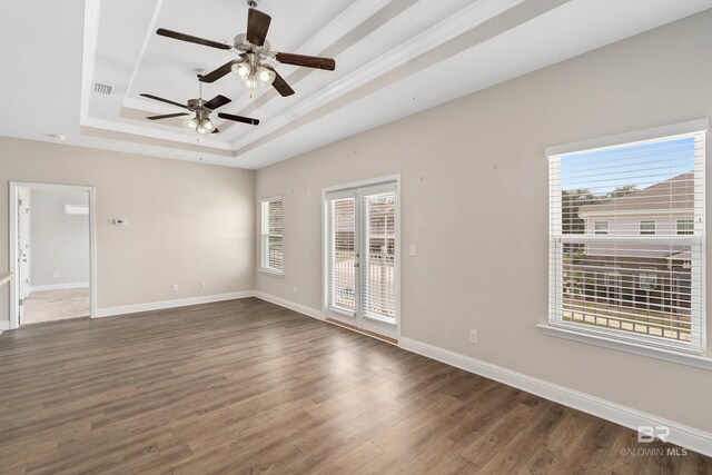 6877 Spaniel Dr Unit A, Spanish Fort, AL 36527 - unfurnished room with a tray ceiling, plenty of natural light, wood finished floors, and ceiling fan