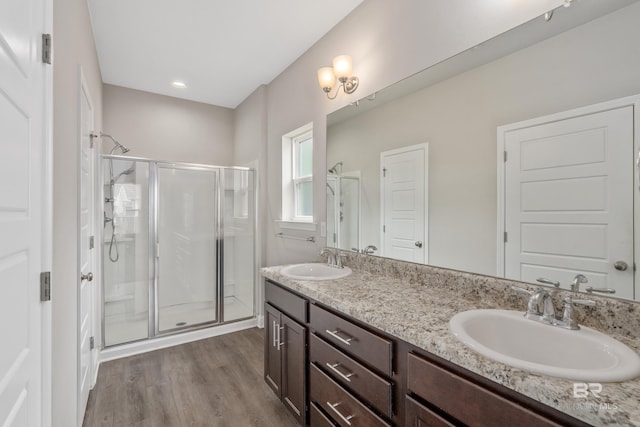 6877 Spaniel Dr Unit A, Spanish Fort, AL 36527 - bathroom with wood finished floors, a sink, a shower stall, and double vanity