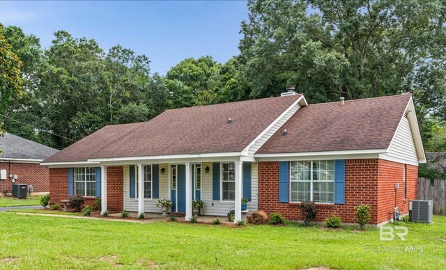 ranch-style home with a front yard, central air condition unit, and a porch