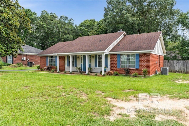 single story home featuring cooling unit and a front lawn