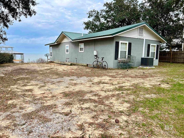 rear view of property with central air condition unit