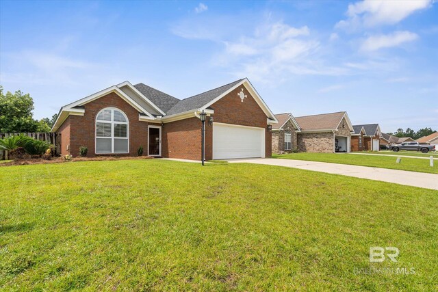 999 Weatherby St, Saraland, AL 36571 - ranch-style house with an attached garage, concrete driveway, brick siding, and a shingled roof