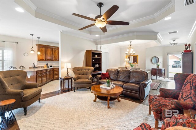 999 Weatherby St, Saraland, AL 36571 - living room with a tray ceiling, ornamental molding, a ceiling fan, a chandelier, and recessed lighting