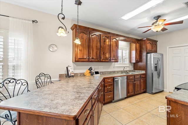 999 Weatherby St, Saraland, AL 36571 - kitchen featuring stainless steel appliances, a peninsula, light tile patterned floors, ceiling fan, and a sink