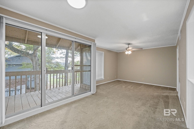 unfurnished room with carpet floors, ceiling fan, and ornamental molding