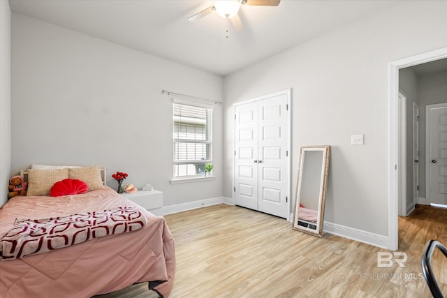 bedroom with a ceiling fan, a closet, baseboards, and wood finished floors